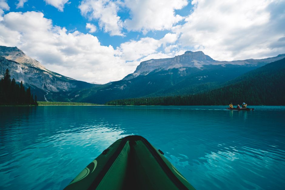 Explore the tranquility of kayaking across Emerald Lake, surrounded by majestic Canadian Rockies in summer.